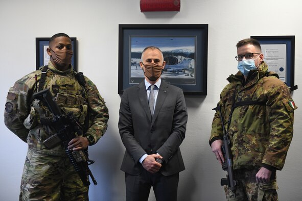 U.S. Airman 1st Class Matthew Minga, 31st Security Forces member, left, Gianni Vignaduzzi, liaison specialist for the defense force commander, center, and Italian Air Force Primo Aviere Scelto Simone S., force protection member, right, pose for a photo at Aviano Air Base, Italy, Dec. 9, 2020. For 26 years, the 31st SFS and Italian Air Force Protection personnel have engaged their best practices and lessons learned on a wide range of topics. (Photo by U.S. Airman 1st Class Ericka A. Woolever)