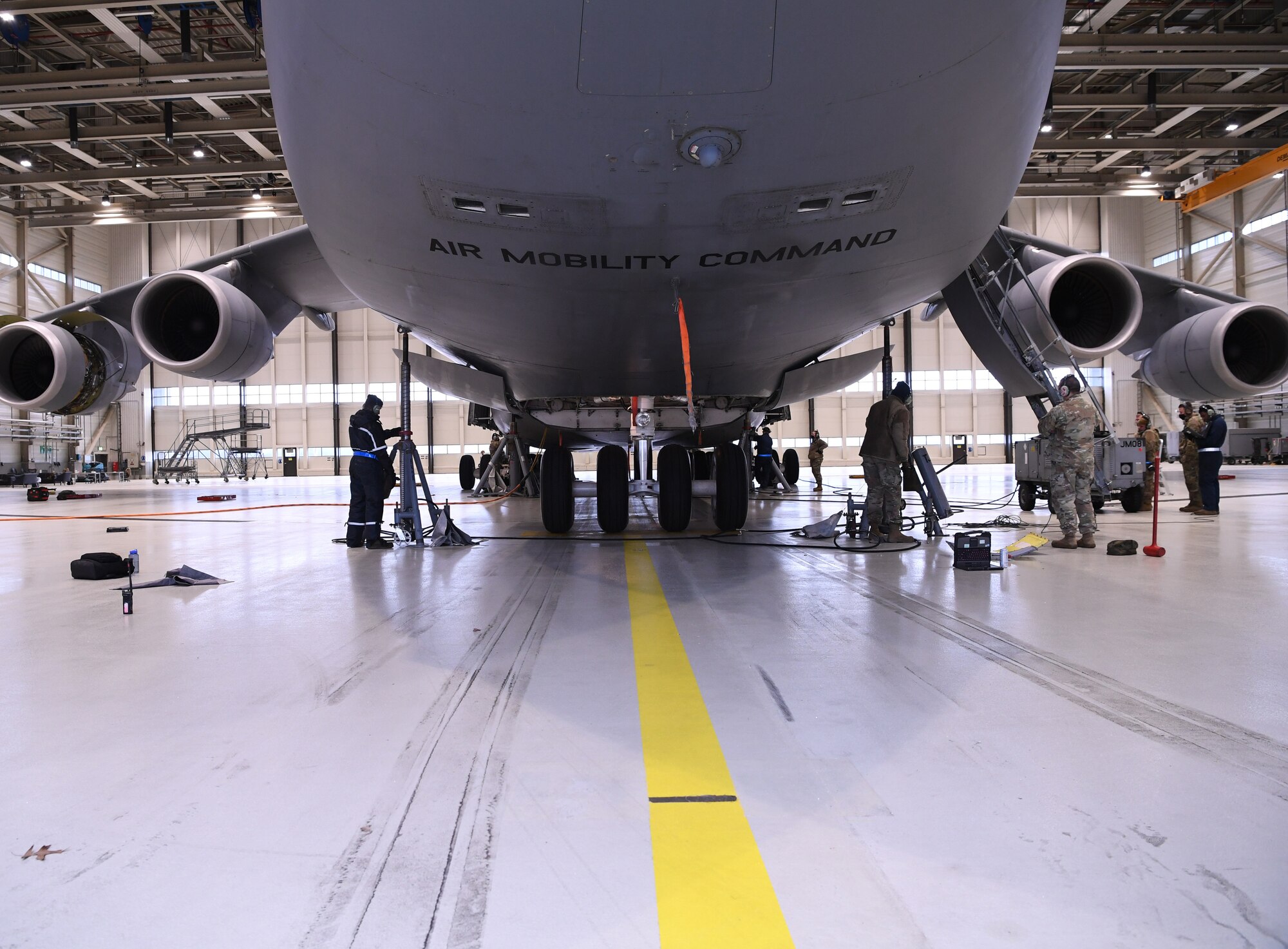 A C-5 Super Galaxy aircraft is placed on aircraft jacks during a 721st Air Mobility Squadron training at Ramstein Air Base, Germany, Dec. 11, 2020. Airmen from Incirlik AB, Turkey, Rota AB, Spain, Spangdahlem AB, Germany, and Ramstein AB attended a training to develop their maintenance proficiency. The 721st Air Mobility Squadron provides command and control, aerial port, and aircraft maintenance in support of the national military strategy to sustain forces worldwide. (U.S. Air Force photo by Senior Airman Thomas Karol)