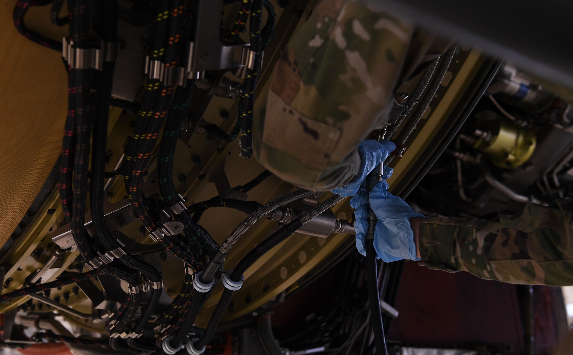 Senior Airman Teyana Jackson, a 725th Air Mobility Squadron aerospace propulsion technician, connects a hose to a C- 5 Super Galaxy aircraft engine during a 721st Air Mobility Squadron training at Ramstein Air Base, Germany, Dec. 11, 2020. Airmen from Incirlik AB, Turkey, Rota AB, Spain, Spangdahlem AB, Germany and Ramstein AB attended the training to develop their maintenance proficiency. The 721st Air Mobility Squadron provides command and control, aerial port, and aircraft maintenance in support of the national military strategy to sustain forces worldwide. (U.S. Air Force photo by Senior Airman Thomas Karol)