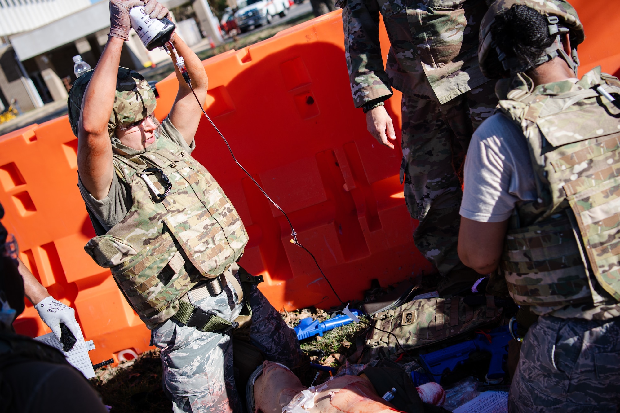 Staff Sgt. Johanna Esquivel, left, 2nd Operational Medical Readiness Squadron medical technician, provides tactical field care to a training dummy during a Tactical Combat Casualty Care (TCCC) field training exercise at Barksdale Air Force Base, La., Dec. 9, 2020.