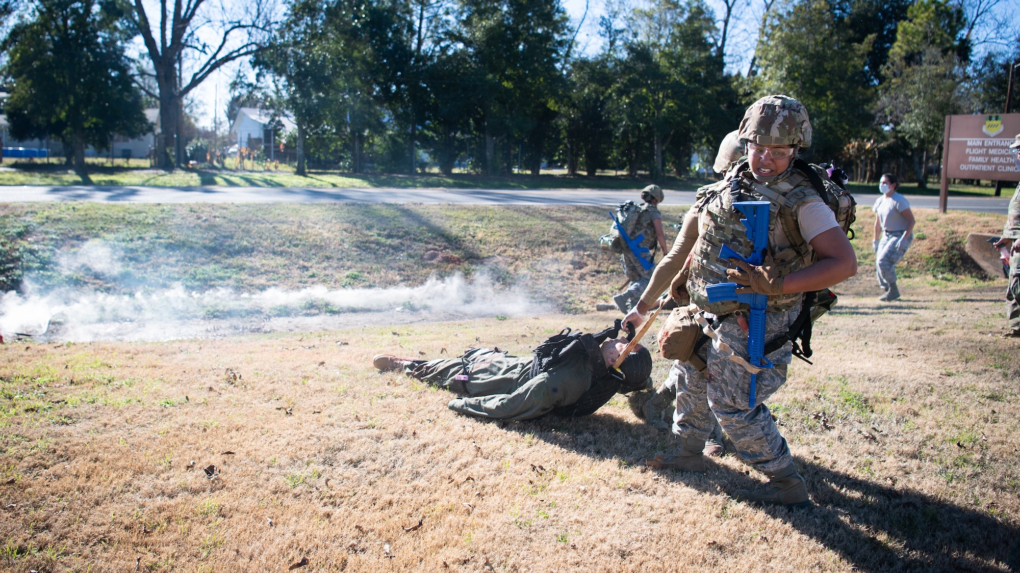 Staff Sgt. Jelisa Adams, 2nd Healthcare Operations Squadron medical technician, and Senior Airman Nikolas Swift, 2nd HCOS medical technician, drag a training dummy during a Tactical Combat Casualty Care (TCCC) field training exercise at Barksdale Air Force Base, La., Dec. 9, 2020.