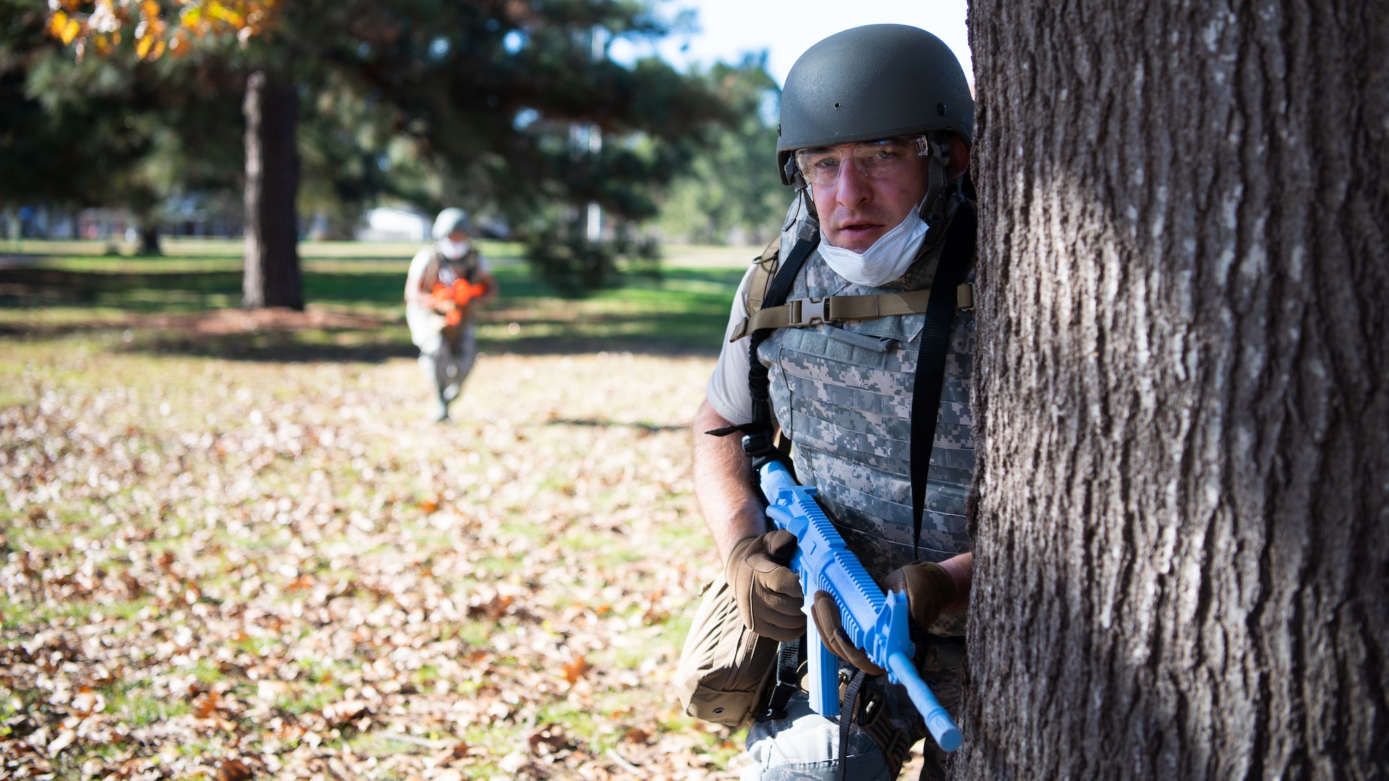 Tech. Sgt. Michael Tomaszewski, Operational Medical Readiness Squadron medical technician, positions himself behind a tree during a Tactical Combat Casualty Care (TCCC) field training exercise at Barksdale Air Force Base, La., Dec. 9, 2020.