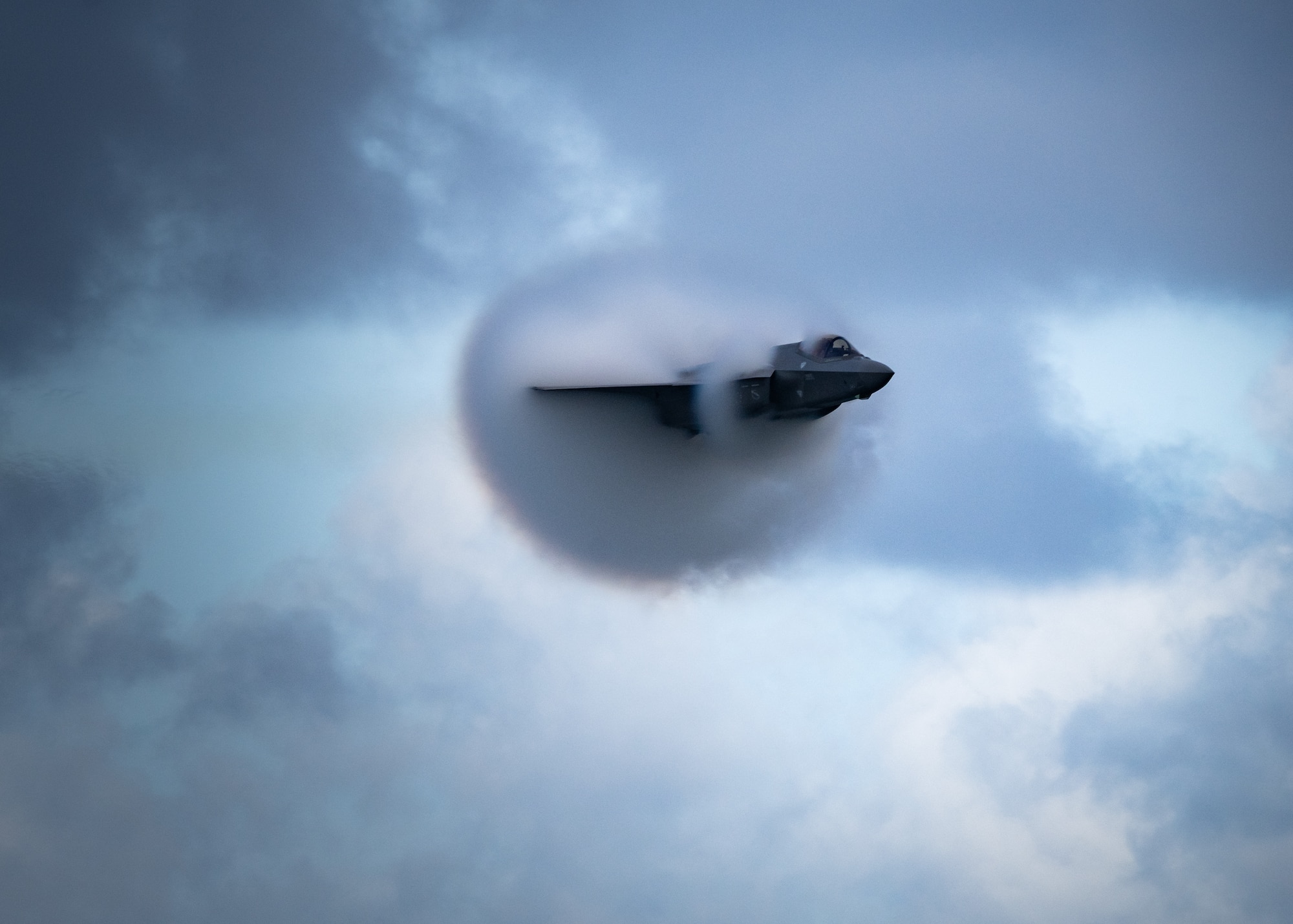 An F-35A Lightning II performing a high-speed pass maneuver.