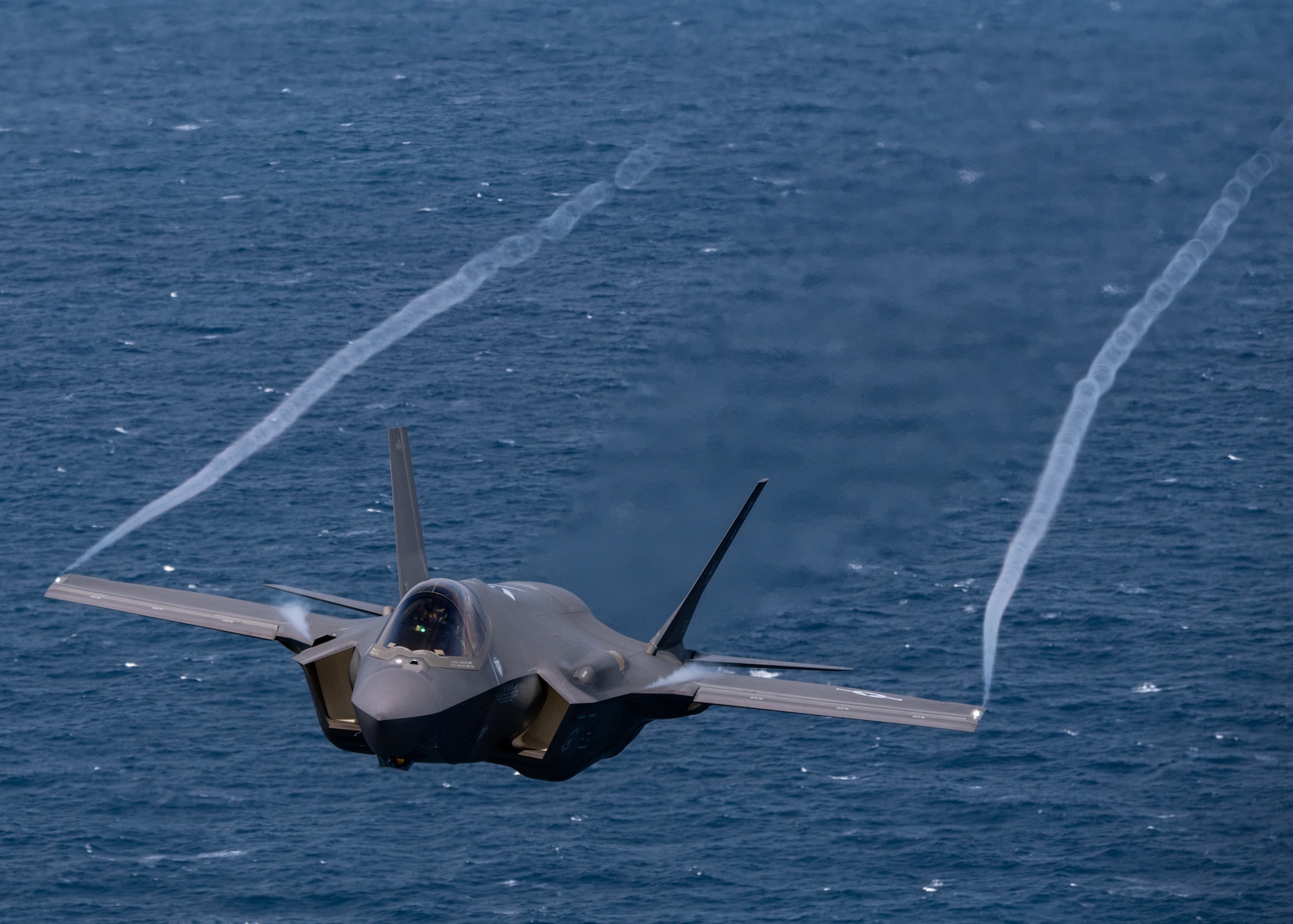 An F-35A Lightning II from the F-35 Demonstration Team flies over the Atlantic Ocean.