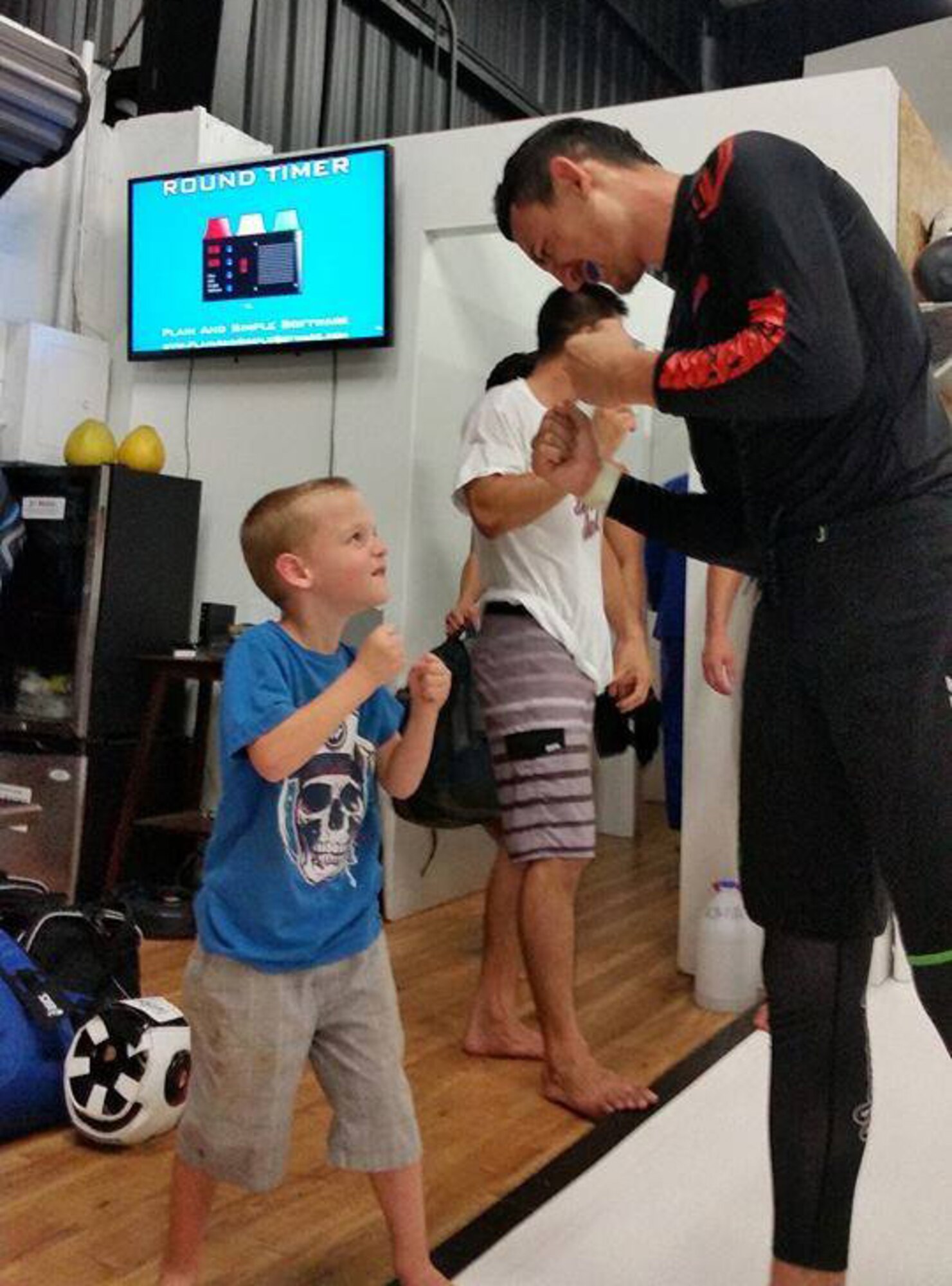 Kyler Atkinson, the son of Master Sgt. Kyle Atkinson, an enlisted accessions recruiter with the 341st Recruiting Squadron, Katy, Texas, squares off with Max Holloway, an Ultimate Fighting Championship fighter and former UFC Featherweight champion.