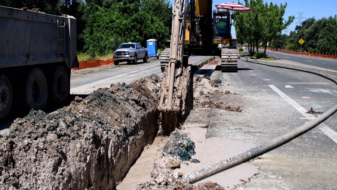 A long-stick excavator digs up material from the center of the Garden Highway roadway in Natomas, California on July 25, 2019. The Natomas Basin is considered by many to be one of the most at-risk regions for catastrophic flooding in the nation. A 42-mile-long levee surrounds the basin, including at this southern location where a main thoroughfare, the two-lane Garden Highway sits atop it.