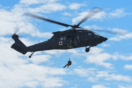 Soldiers with Charlie Company, 3rd Battalion, 126th Aviation Regiment, 86th Troop Command, Garrison Support Command, Vermont National Guard, performed hoist training with UH-60 Black Hawk helicopters over Camp Johnson in Colchester, Vermont, Aug. 7, 2020. The Soldiers were conducting training as part of their annual training. (Photo by U.S. Army National Guard 2nd Lt. Nathan Rivard)