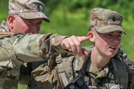 Vermont State Command Sgt. Maj. Nathan Chipman guides Pfc. Haley Hawthorne, New Hampshire Army National Guard, to the final event of the Best Warrior Competition Aug. 16. The Vermont Army National Guard hosted the Region One Best Warrior Competition at the Ethan Allen Firing Range in Jericho, Vermont, Aug. 14-16. The New York National Guard took the top spot in both the Noncommissioned Officer and Enlisted categories. (Photo by Sgt. 1st Class Jason Alvarez, 172nd PAD, VTARNG)