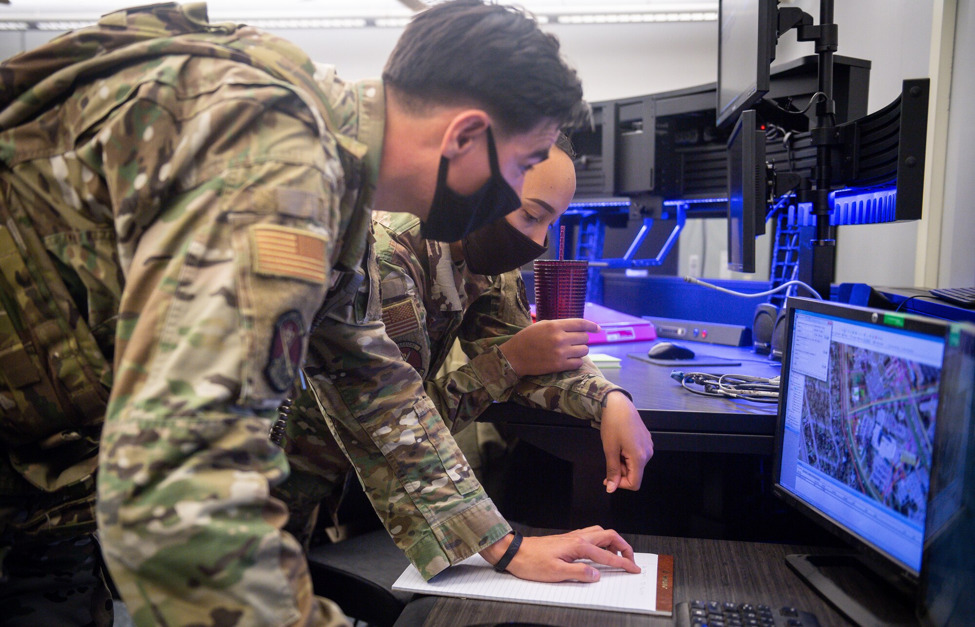 Staff Sgt. Robert Bieber, 2nd Security Forces base dispatch operator, and Staff Sgt. Brianne Davis-Robertson, 2nd SFS evaluator, pinpoint coordinates of a crash site at Barksdale Air Force Base, La., Dec. 16, 2020. Airmen from the 2nd SFS, 2nd Civil Engineer Squadron, 2nd Medical Group, 2nd Logistics Readiness Squadron and local authorities worked in conjunction to locate and effectively respond to a civilian light aircraft crash on the east side of Barksdale. (U.S. Air Force photo by Senior Airman Lillian Miller)