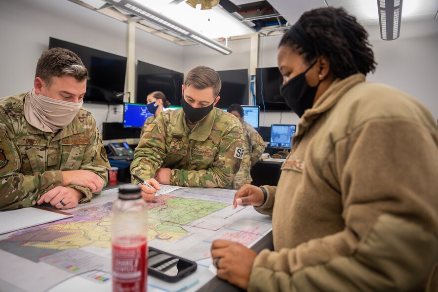 Tech. Sgt. Joseph McCoy, Tech. Sgt. Eric Hill, 2nd Security Forces Squadron flight chiefs, and Master Sgt. Tamieka Morgan, 2nd SFS defense force operator, search for a route to a crash site at Barksdale Air Force Base, La., Dec. 16, 2020. Airmen from the 2nd SFS, 2nd Civil Engineer Squadron, 2nd Medical Group, 2nd Logistics Readiness Squadron and local authorities worked in conjunction to locate and effectively respond to a civilian light aircraft crash on the east side of Barksdale. (U.S. Air Force photo by Senior Airman Lillian Miller)