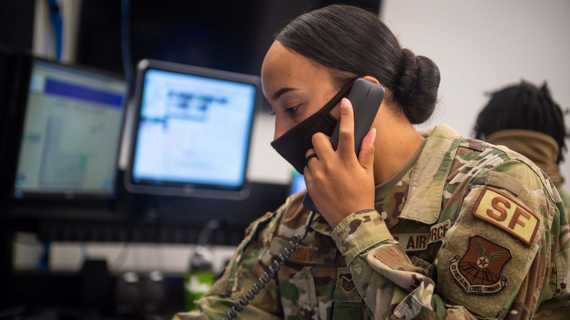 Staff Sgt. Brianne Davis-Robertson, 2nd Security Forces Squadron evaluator, answers phones and coordinates search and rescue efforts after a civilian light aircraft at Barksdale Air Force Base, La., Dec. 16, 2020. Airmen from the 2nd SFS, 2nd Civil Engineer Squadron, 2nd Medical Group, 2nd Logistics Readiness Squadron and local authorities worked in conjunction to locate and effectively respond to a civilian light aircraft crash on the east side of Barksdale. (U.S. Air Force photo by Senior Airman Lillian Miller)