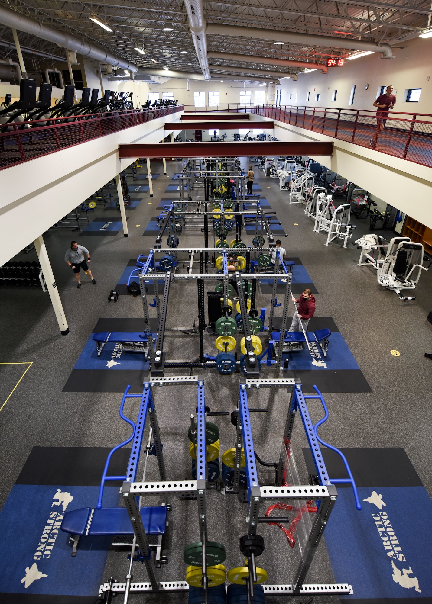 Joint Base Elmendorf-Richardson personnel use free weights and professional grade equipment sitting ready for use in the Elmendorf Fitness Center at JBER, Alaska, Dec 14, 2020. In addition to state-of-the-art equipment the center also includes specialized work out rooms, basketball courts, an indoor running track and an abundance of new strength and cardio machines. (U.S. Air Force photo by Senior Airman Crystal A. Jenkins)