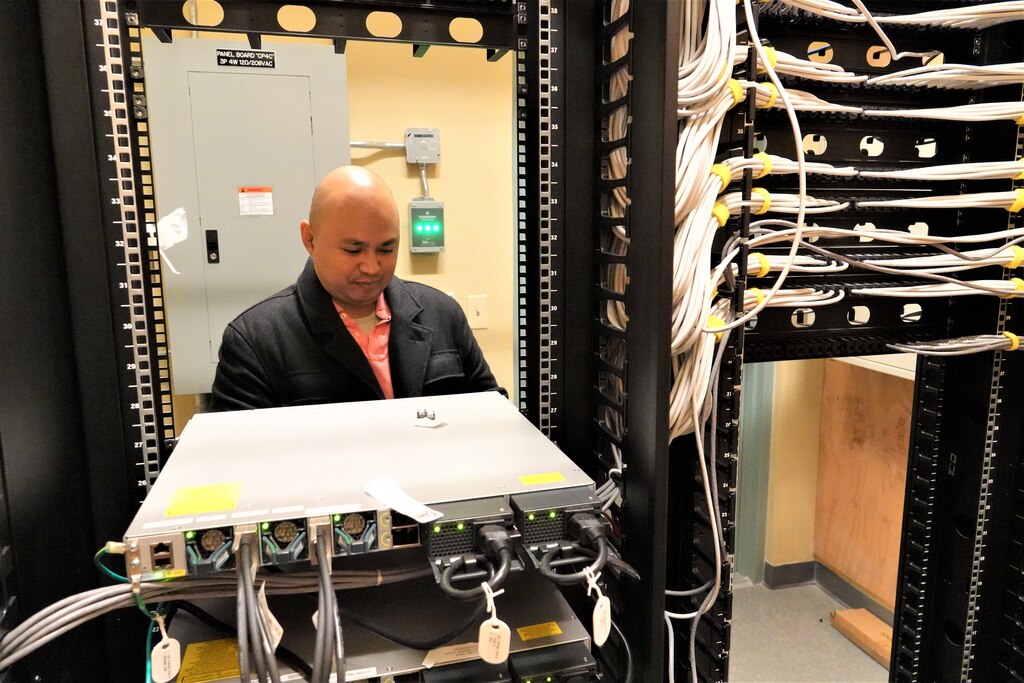 Aaron Aguilar, Information Technology Specialist/Telecommunication Officer works in one of the
District's telecommunications rooms.