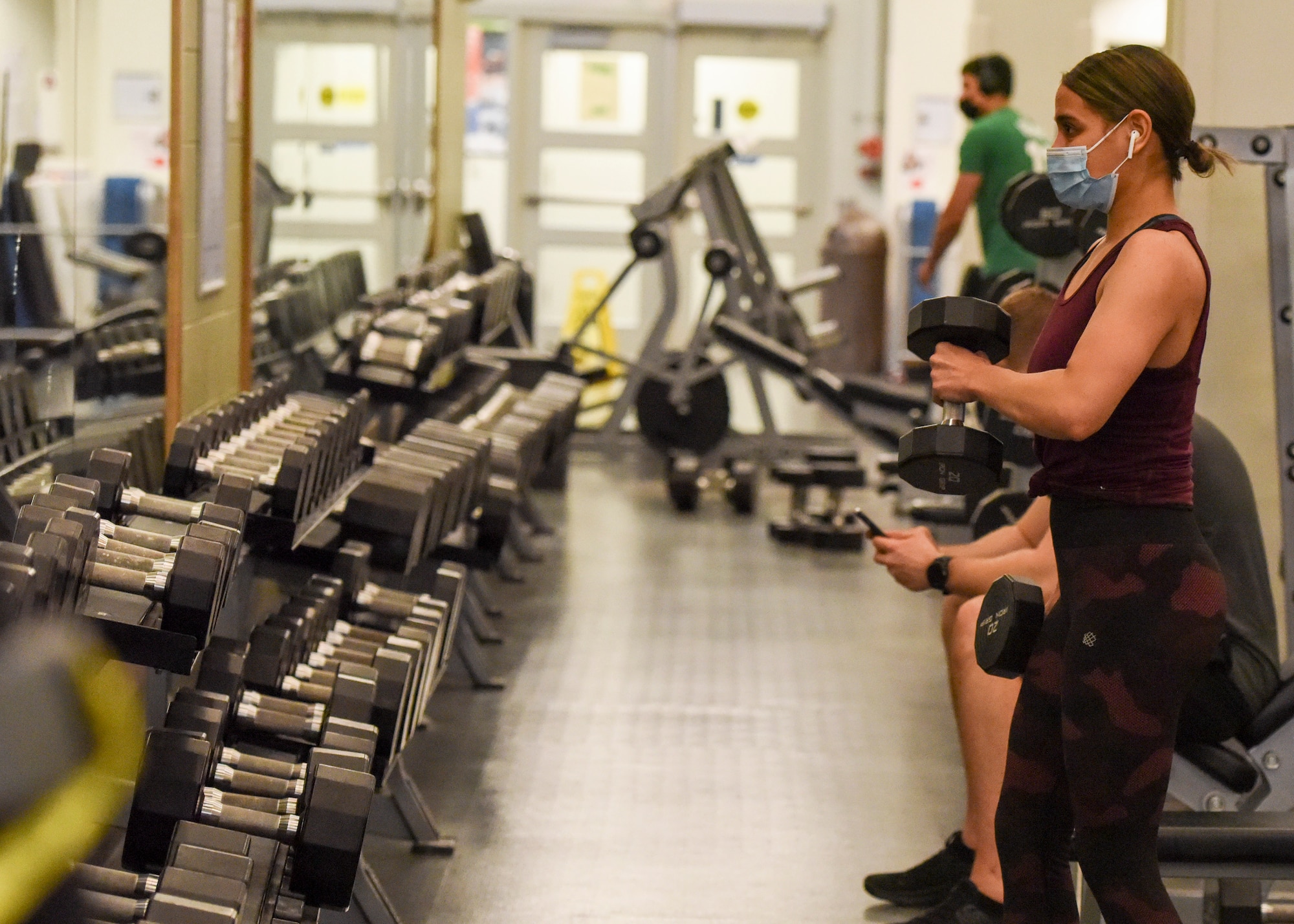 Kimberly Laureano, wife of U.S. Army Staff Sgt. Roman Duran, lifts 20-pound free weights at the Buckner Fitness Center on Joint Base Elmendorf-Richardson, Alaska, Dec 14, 2020. In addition to state-of-the-art equipment Buckner also includes an aquatic center, fitness pool, rock climbing wall, an indoor running track and an abundance of new strength and cardio machines. (U.S. Air Force photo by Senior Airman Crystal A. Jenkins)