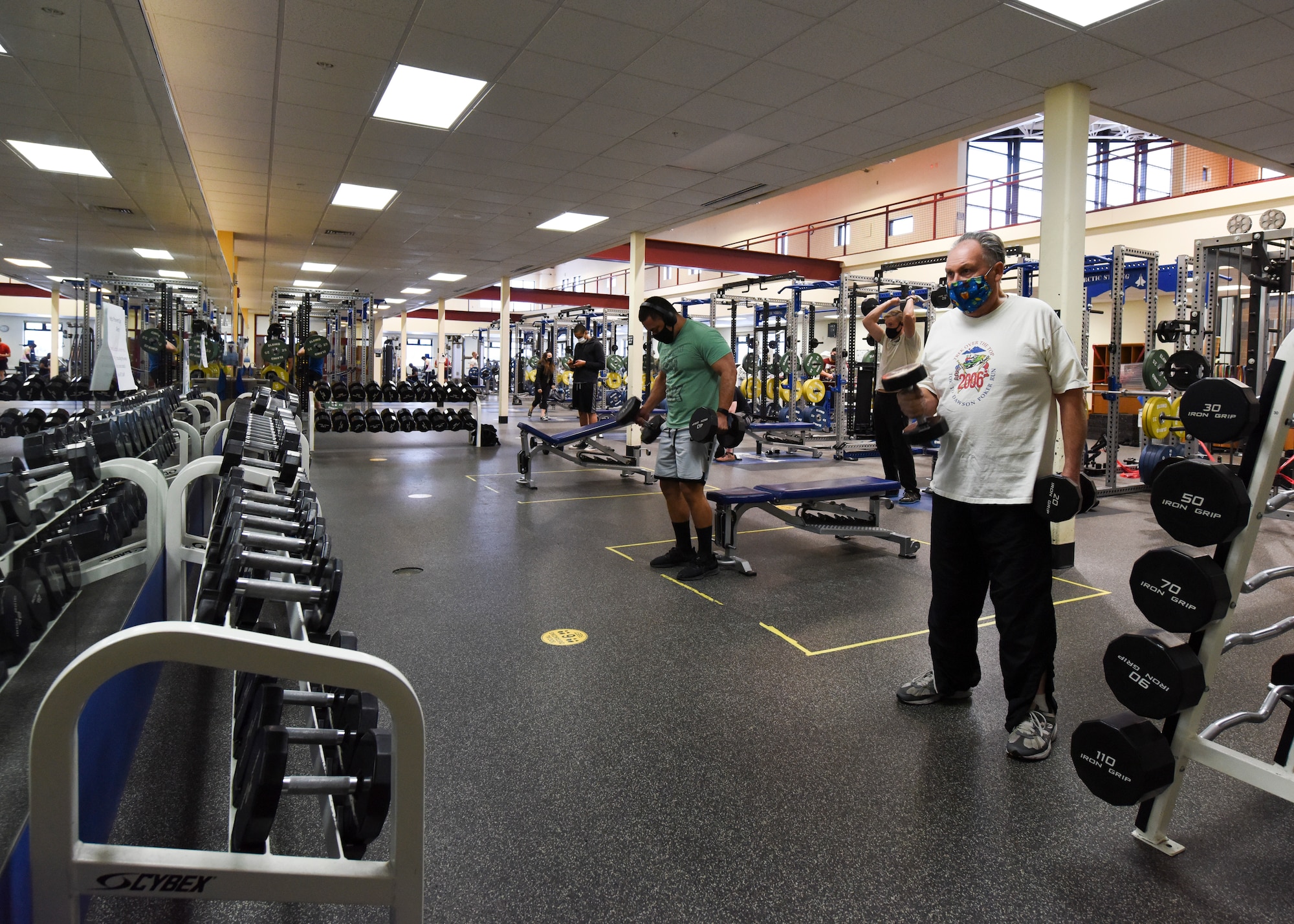 Joint Base Elmendorf-Richardson personnel use free weights and professional grade equipment sitting ready for use in the Elmendorf Fitness Center at JBER, Alaska, Dec 14, 2020. In addition to state-of-the-art equipment the center also includes specialized work out rooms, basketball courts, an indoor running track and an abundance of new strength and cardio machines. (U.S. Air Force photo by Senior Airman Crystal A. Jenkins)