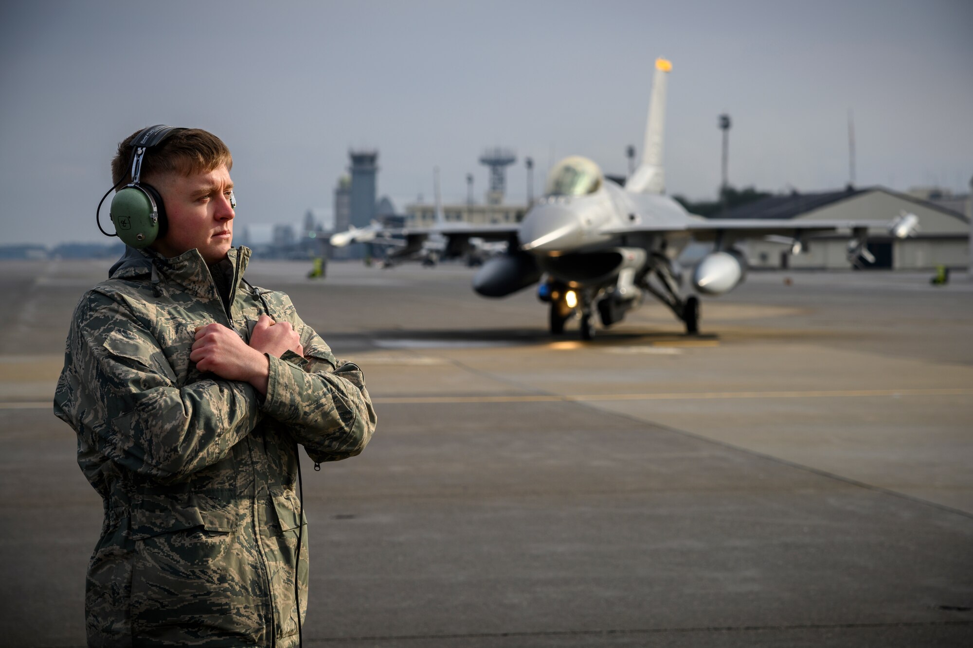 U.S. Air Force Airman Corey Tidwell, a 35th LRS fuels distribution journeyman, prepares to marshal an F-16 Fighting Falcon during Agile Combat Employment week at Misawa Air Base, Japan, Dec. 10, 2020. The 35th LRS tested a new cargo deployment function (CDF) process that centralized representatives from all units and their unpacked cargo in one location to collectively pack individual storage units, reducing the CDF timeline and deployment footprint. (U.S. Air Force photo by Airman 1st Class China M. Shock)