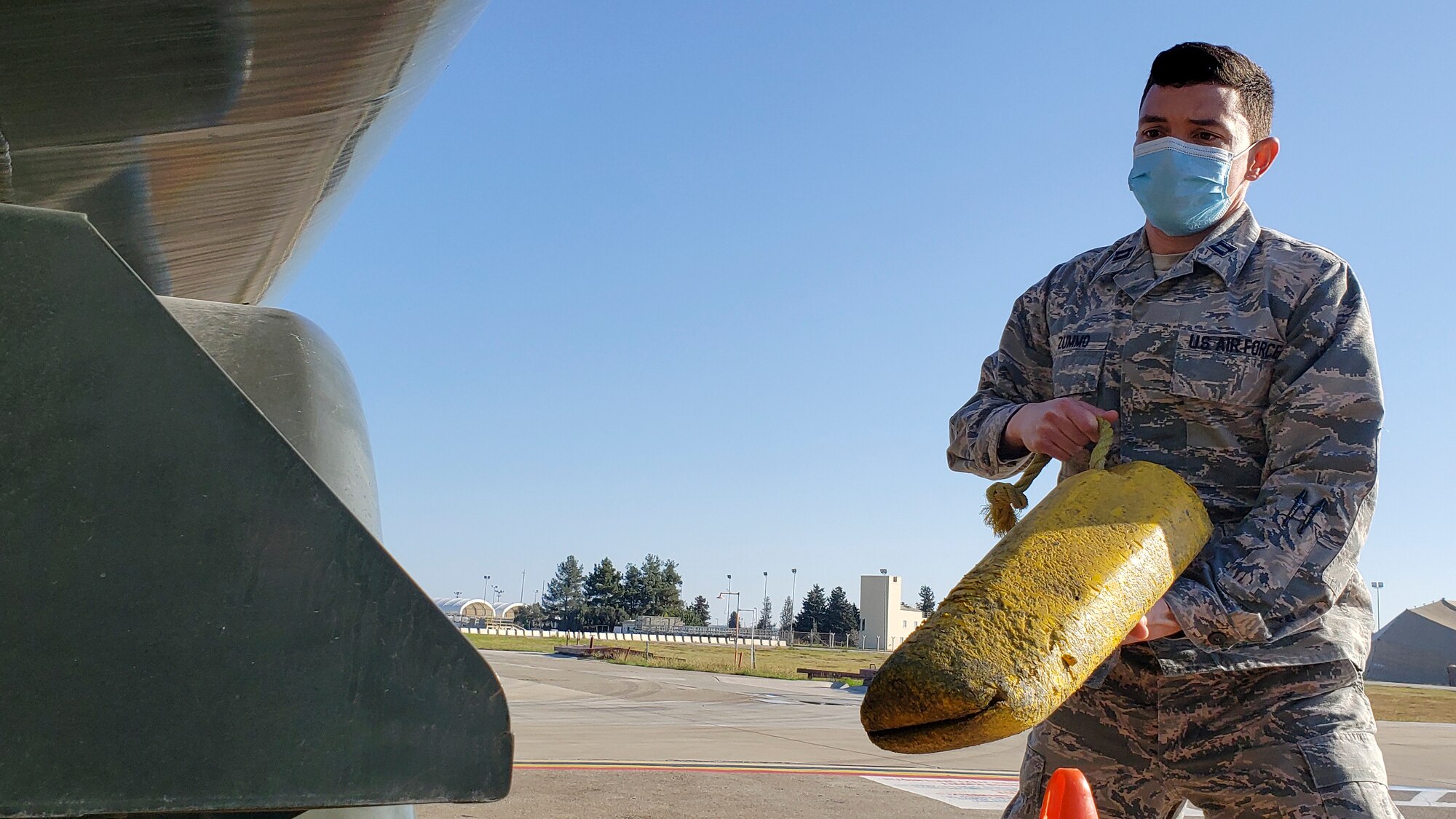 Airman carrying a parking chalk