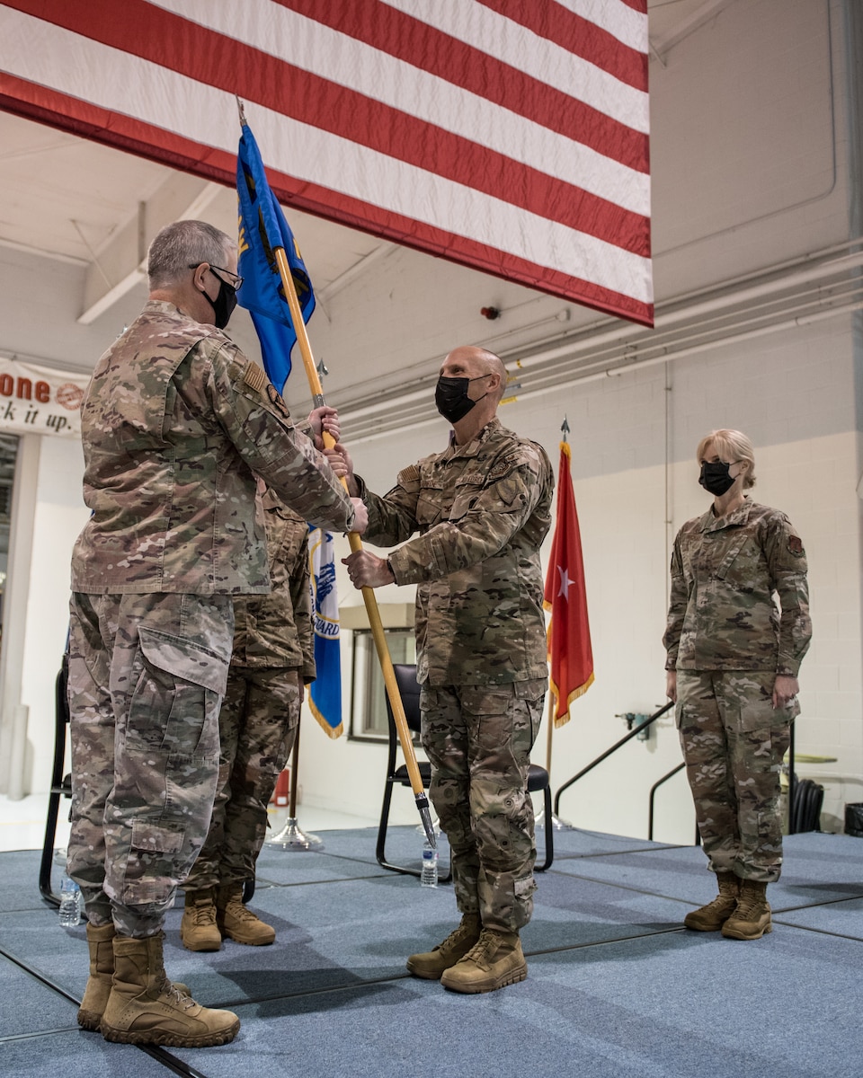 Col. George H. Imorde III (center), incoming commander of the 123rd Mission Support Group, receives the group’s guidon from Col. David Mounkes (left), commander of the 123rd Airlift Wing, during a change-of-command ceremony at the Kentucky Air National Guard Base in Louisville, Ky., on Nov. 14, 2020. Imorde previously served as the 123rd Security Forces Squadron commander and antiterrorism officer for the 123rd Airlift Wing. (U.S. Air National Guard photo by Staff Sgt. Joshua Horton)
