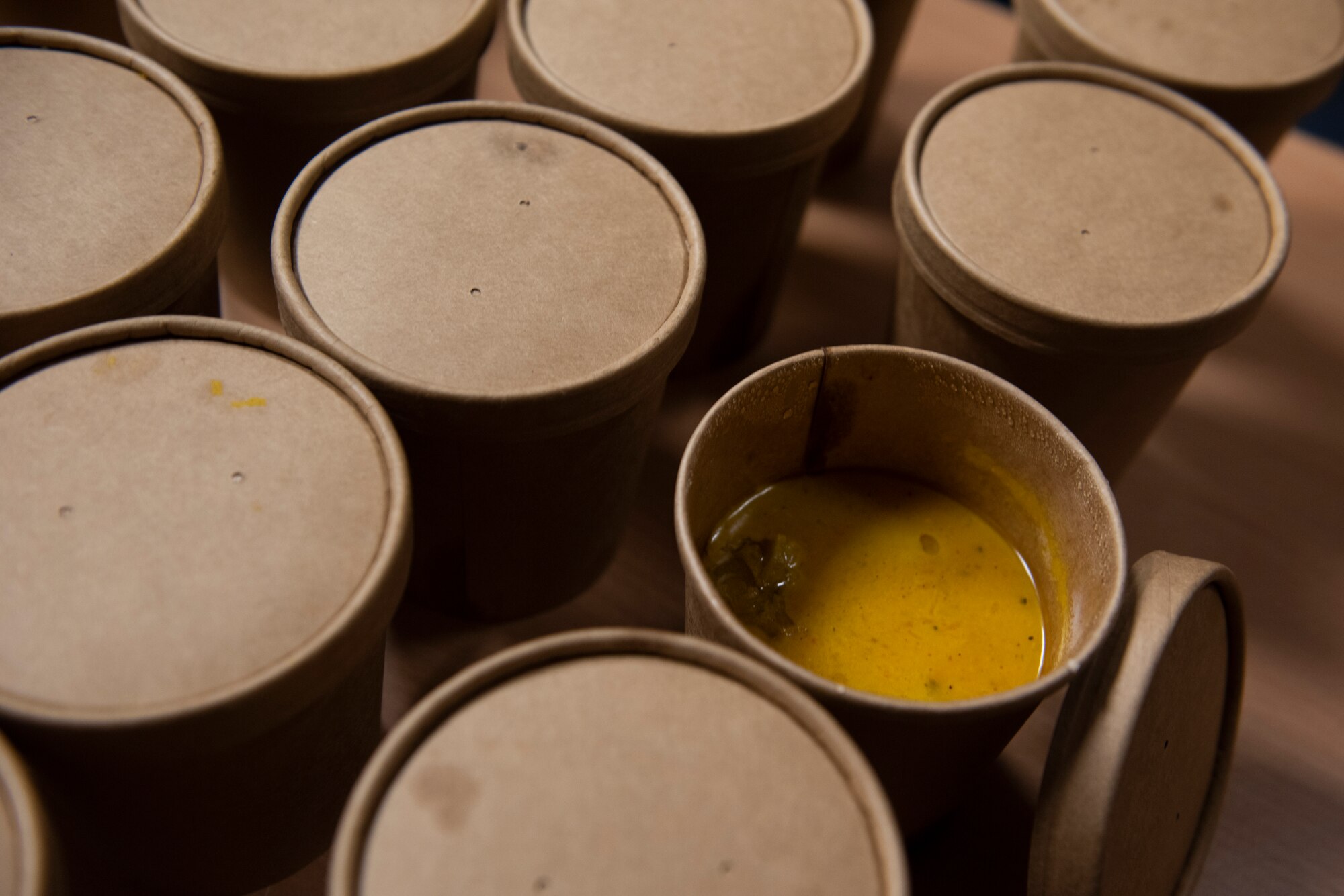 A photo of soup sitting on a table.
