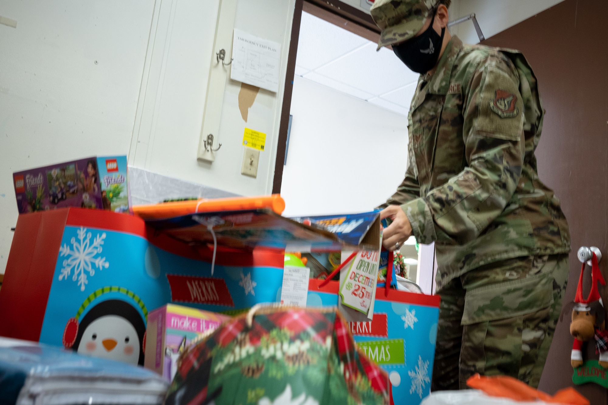 Tech. Sgt. Ashley Mooney, 154th Logistics Readiness Squadron first sergeant organizes donations and gifts collected from Hawaii Air National Guard Airmen and units for an Angel Tree project at Joint Base Pearl Harbor-Hickam, Dec. 8, 2020. The Angel Tree is a charitable program that collects donations to fulfill christmas wishlists for elderly and children in need. HIANG Airmen have given enough donations to fulfill more than 80 separate christmas wishlists for the Salvation Army sponsored project. (U.S. Air National Guard photo by Senior Airman John Linzmeier)