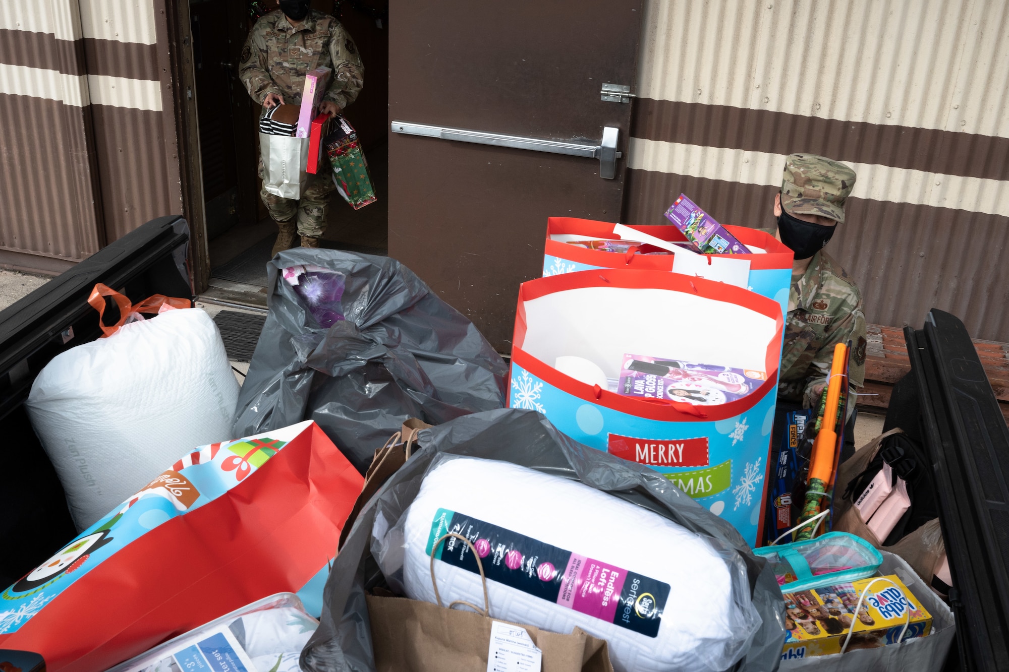 Hawaii Air National Guard 154th Logistics Readiness Squadron Airmen load donations and gifts onto a truck bed for delivery for an Angel Tree project at Joint Base Pearl Harbor-Hickam, Dec. 8, 2020. The Angel Tree is a charitable program that collects donations to fulfill christmas wishlists for elderly and children in need. HIANG Airmen have given enough donations to fulfill more than 80 separate christmas wishlists for the Salvation Army sponsored program. (U.S. Air National Guard photo by Senior Airman John Linzmeier)