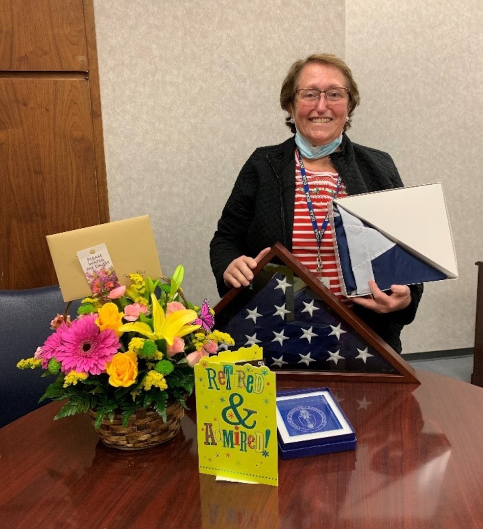 lady posing with gifts and flowers