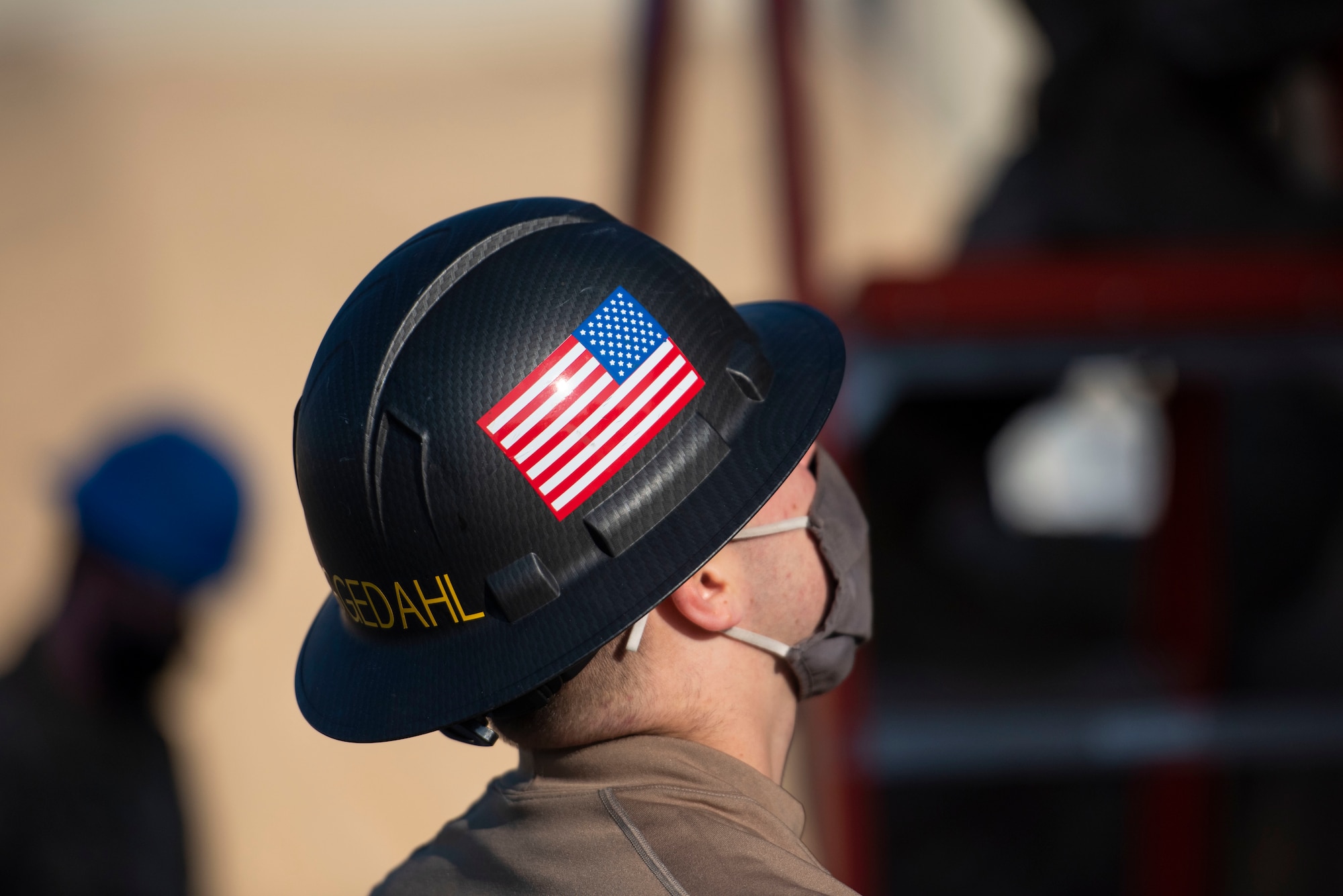 Man wearing hard hat with American flag sticker