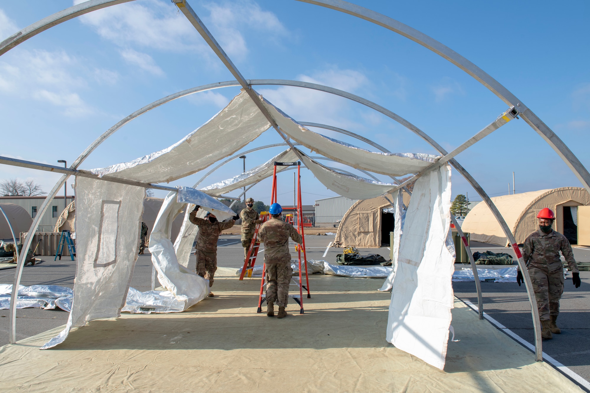 Members building a tent