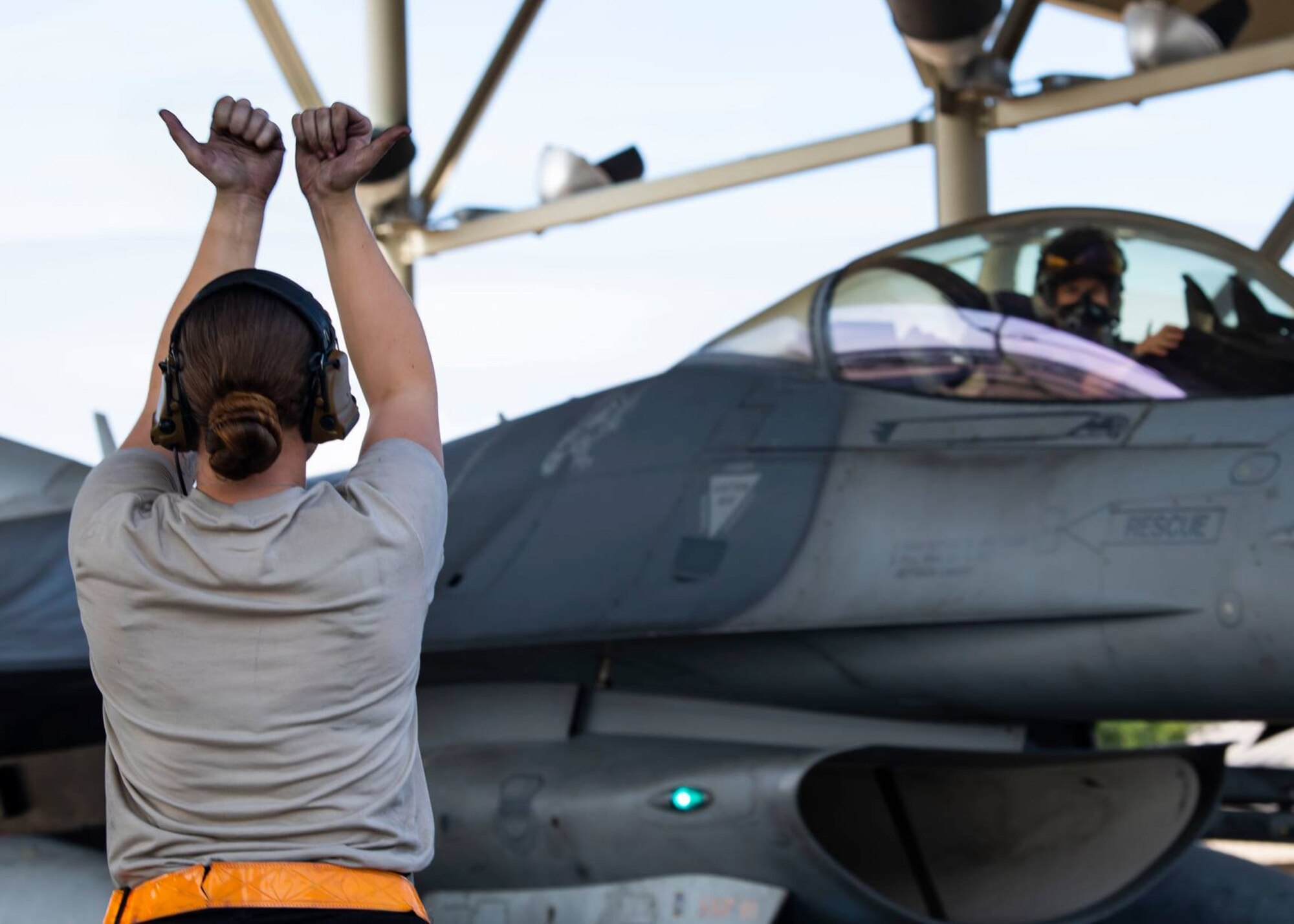 Airman marshals a jet