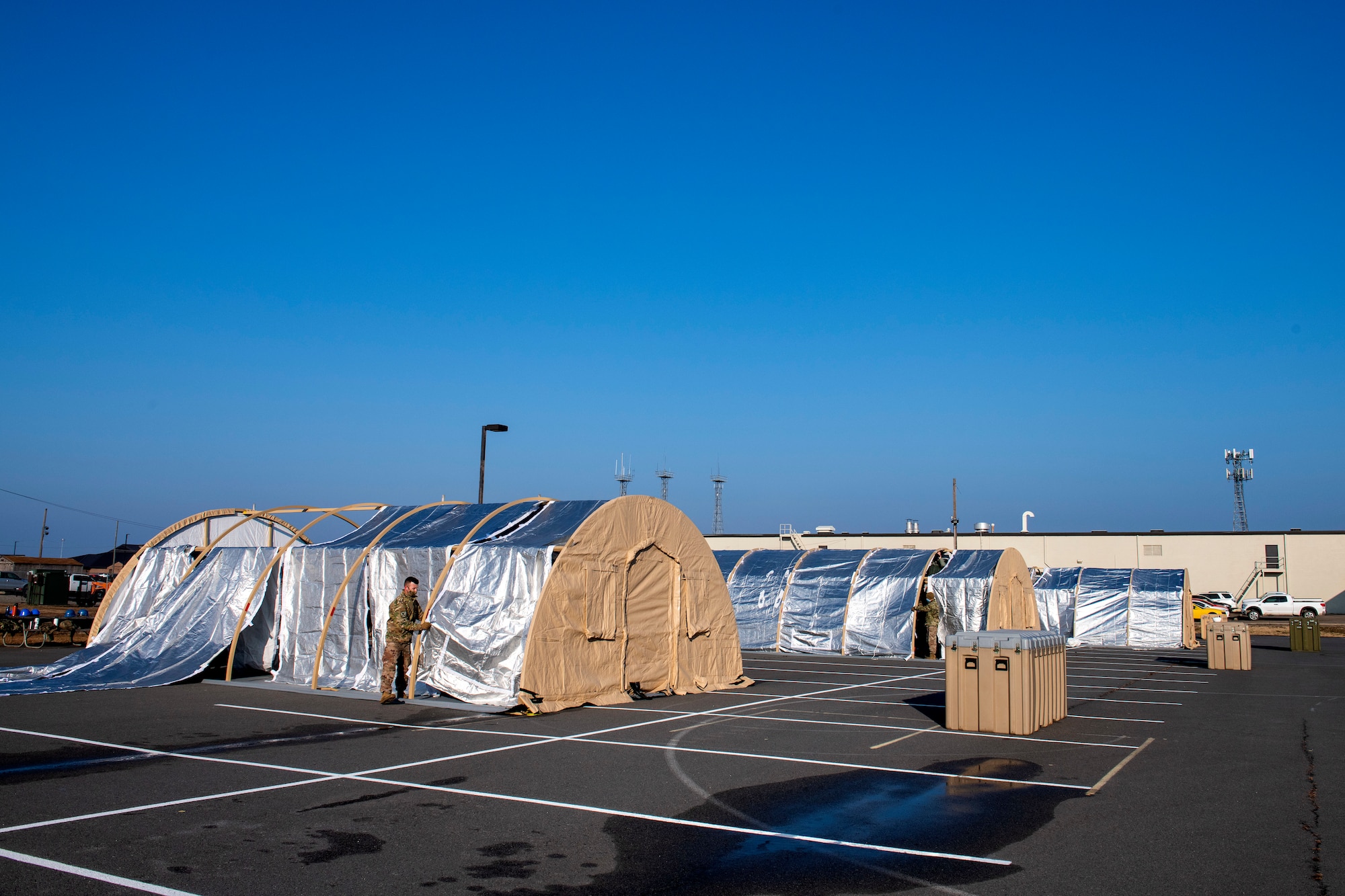 four large tents in different stages of being completed