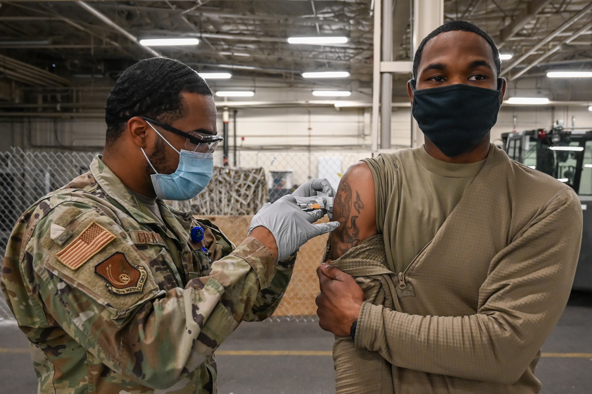 Tech. Sgt. Deshawn Scott, 75th Logistics Readiness Squadron, receives a flu vaccination shot Dec. 17, 2020, at Hill Air Force Base, Utah, from Airman 1st Class Carlos Cheatham, 75th Medical Group. The CDC recommends seasonal influenza vaccine for all people 6 months of age and older. The best way to prevent seasonal flu is to get vaccinated every year. (U.S. Air Force photo by Cynthia Griggs)