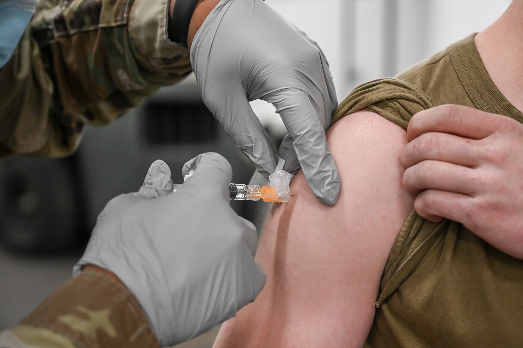An Airmen receives a flu vaccination shot Dec. 17, 2020, at Hill Air Force Base, Utah, from Airman 1st Class Carlos Cheatham, 75th Medical Group. The CDC recommends seasonal influenza vaccine for all people 6 months of age and older. The best way to prevent seasonal flu is to get vaccinated every year. (U.S. Air Force photo by Cynthia Griggs)