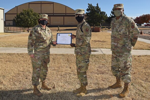 U.S. Air Force Col. Angelina Maguiness, 17th Training Group commander, presents Airman 1st Class Wilson Jevoghn, 315th Training Squadron student, the 17th TRG Rope of the Month award outside of the Brandenburg Hall on Goodfellow Air Force Base, Texas, Dec. 11, 2020. Jevoghn worked hard for his award and had shown his dedication to his squadron and the training he received at Goodfellow. (U.S. Air Force photo by Senior Airman Abbey Rieves)