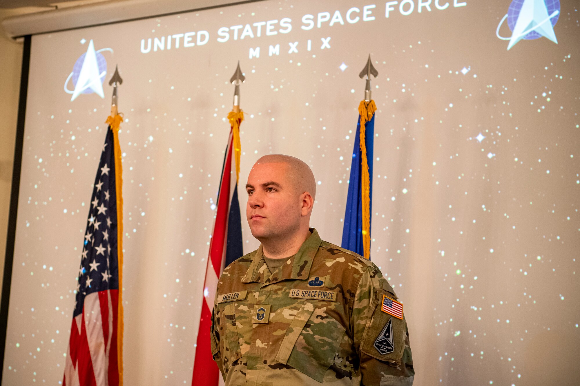 U.S. Air Force Senior Master Sgt. Kyle Mullen, 423rd Communications Squadron superintendent, stands at attention during a United States Space Force induction ceremony at RAF Alconbury, England, Dec. 18, 2020. Mullen became the first Airman from the 501st Combat Support Wing to transition into the USSF. (U.S. Air Force photo by Senior Airman Eugene Oliver)