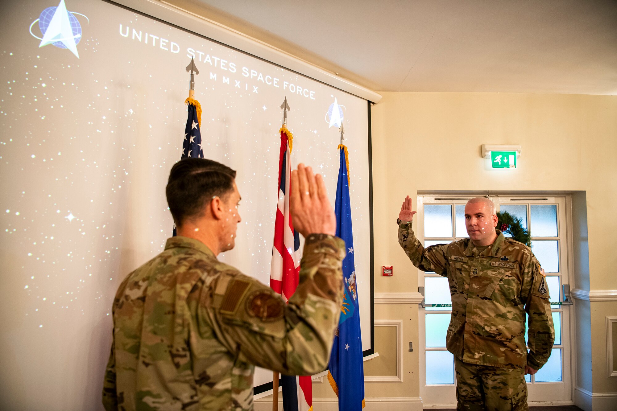 U.S. Air Force Senior Master Sgt. Kyle Mullen, right, 423rd Communications Squadron superintendent, takes the oath of enlistment to transition into the United States Space Force at RAF Alconbury, England, Dec. 18, 2020. Mullen became the first Airman from the 501st Combat Support Wing to transition into the USSF. (U.S. Air Force photo by Senior Airman Eugene Oliver)