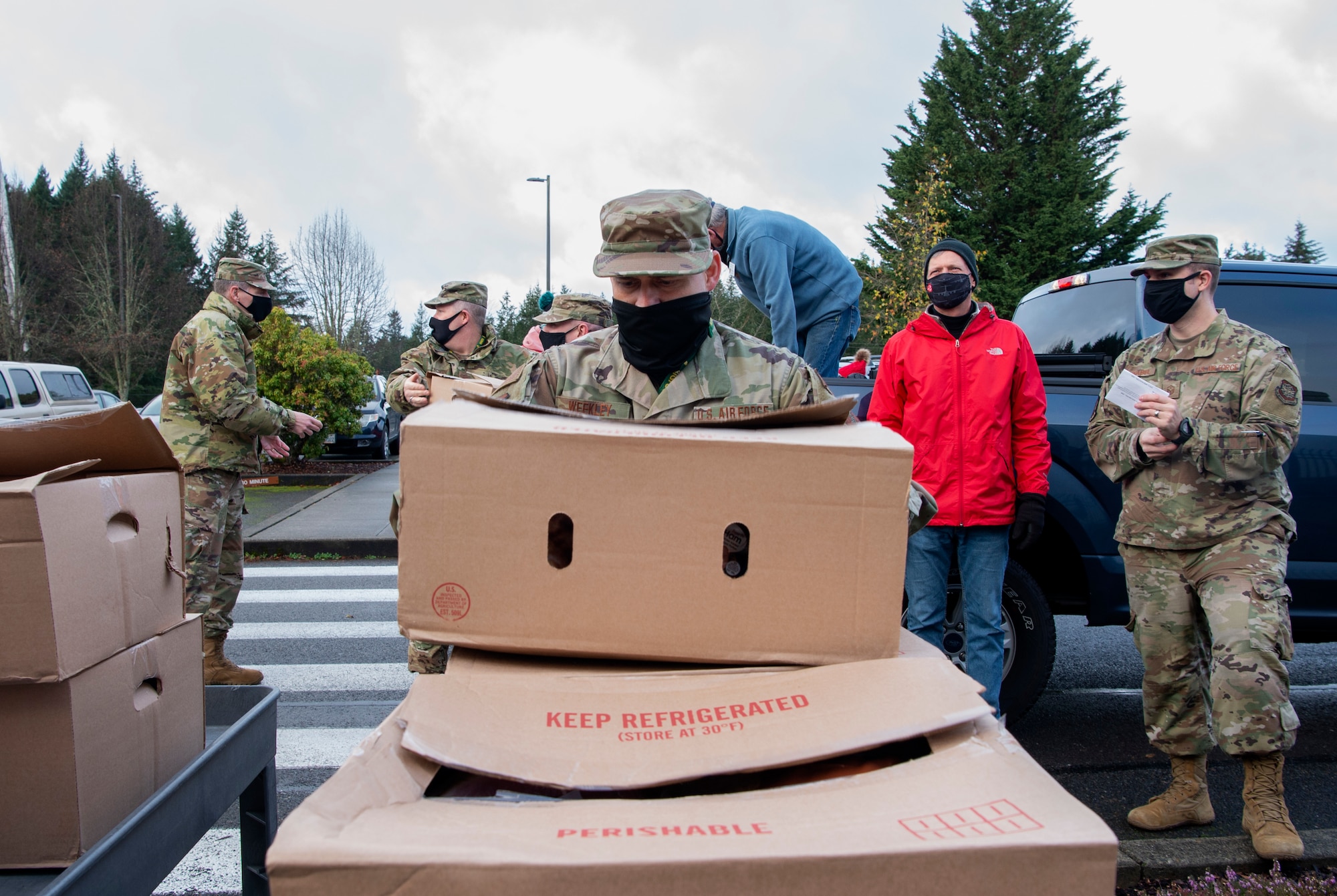 Team McChord Airmen and civilians participate in the Operation Ham Grenade at Joint Base Lewis-McChord, Wash., Dec. 17, 2020. More than 350 hams were donated to Team McChord Airmen and their families during the holidays. (U.S. Air Force photo by Senior Airman Tryphena Mayhugh)