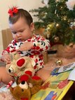 A baby plays with toy bears