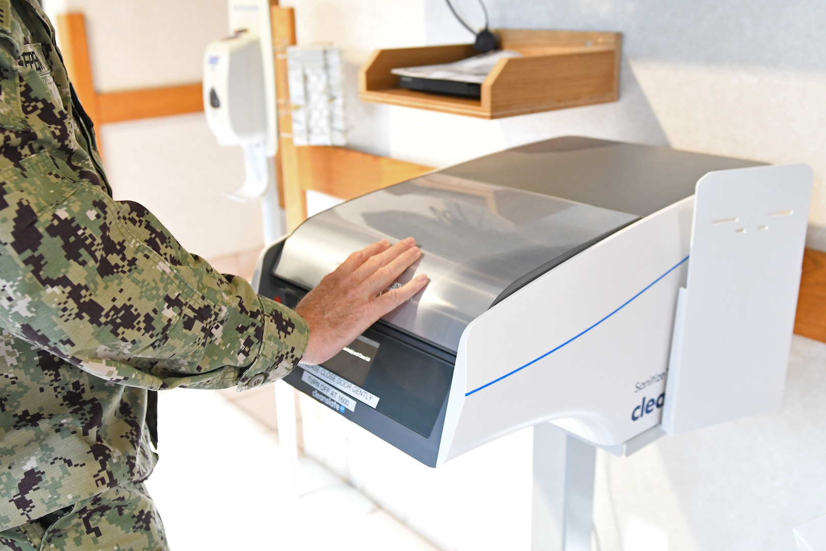 Officer closes sanitation machine.