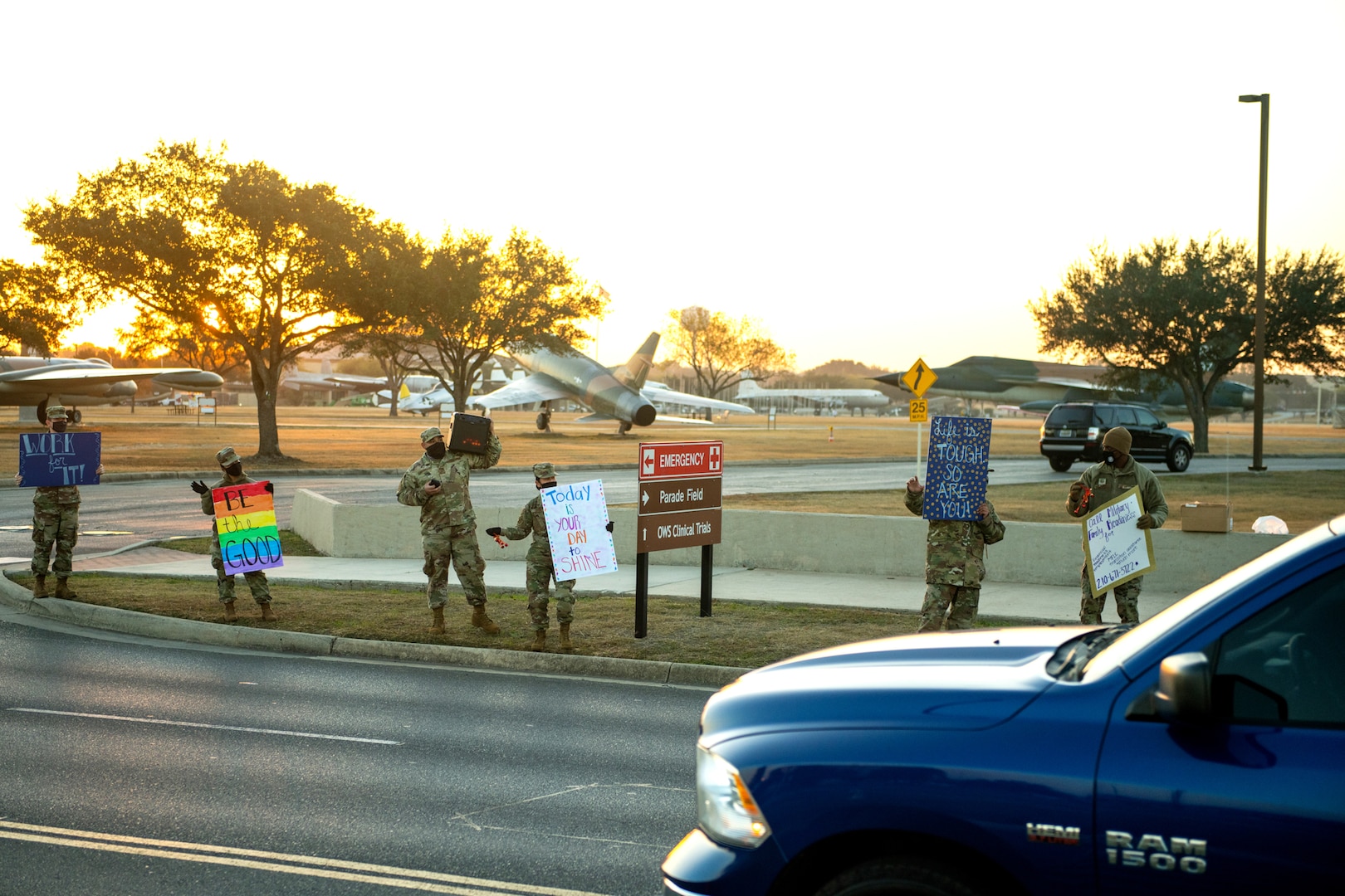 U.S. Air Force military members hold signs to spread holiday cheer for drivers to see Dec. 18, 2020, at Joint Base San Antonio-Lackland, Texas.
