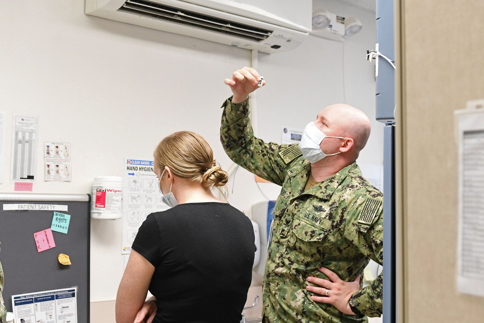 Sailor dilutes COVID-19 vaccine.