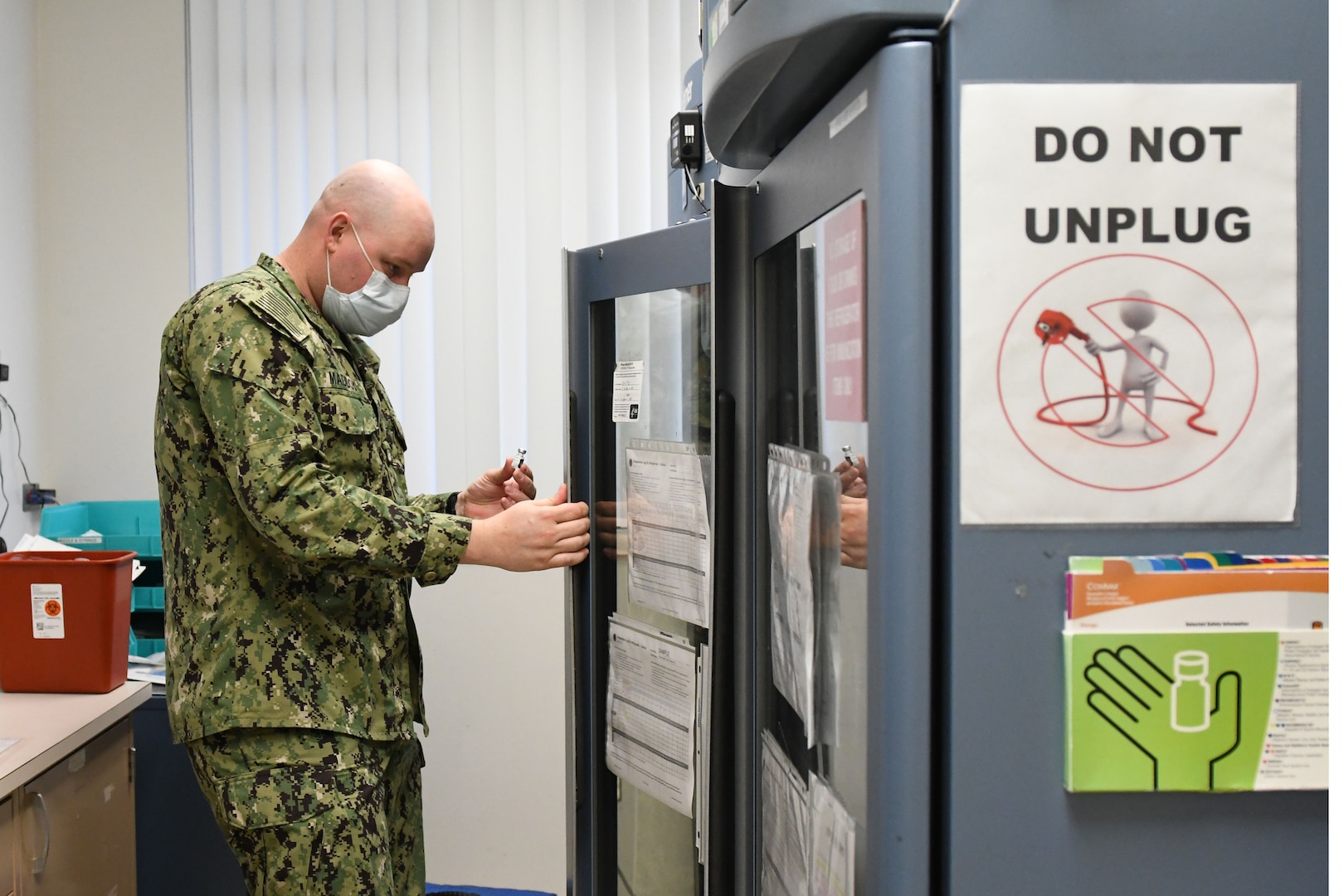 Sailor puts vaccine in the refrigerator.