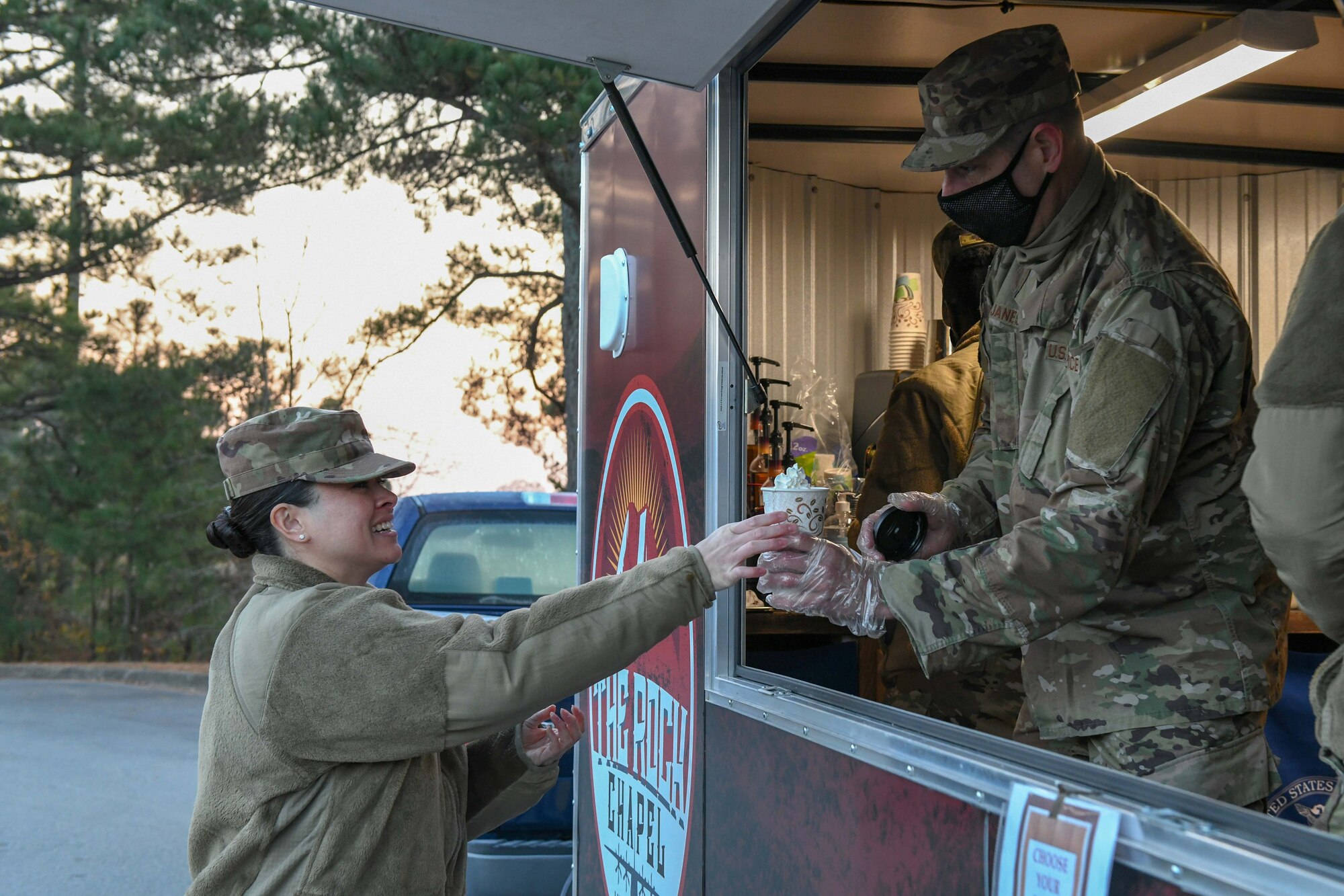 a man gives coffee to a woman