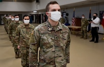 Cadet Dan Borbely and other cadets from the University of Vermont ROTC prepare to receive Military Funeral Honors training certificates from Stephen Holt (background, right) during a ceremony at Camp Johnson, Vermont, Dec. 18, 2020. The cadets completed the first 40-hour course offered by the Vermont National Guard since 2010. The course trains Soldiers how to render honors at funeral services and perform color guards and other ceremonies. Holt is the state MFH program coordinator. (U.S. Army National Guard photo by Don Branum)