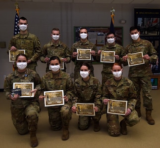 University of Vermont ROTC cadets pose for a group photo after completing a 40-hour Military Funeral Honors training program at Camp Johnson, Vermont, Dec. 18, 2020. The cadets are: (Top Row) Nicholas Welsh, Timothy Forkey, Dan Borbely, Seth Cournoyer, and Teagan Poliseno; (Bottom Row) Hannah Minns, Taylor Catlin, Haley Kieny, and Alyssa Ellis. (U.S. Army National Guard photo by Don Branum)