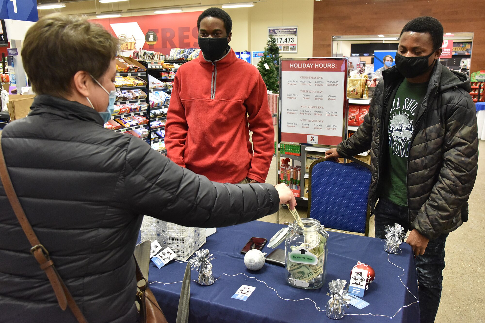 Airmen 1st Class Stephen L. Blyden, left, and Loglo A. Kouava, 341st Civil Engineer Squadron electrical power production apprentices, raise money for Operation Warm Heart Dec. 11, 2020, at Malmstrom Air Force Base, Mont. Operation Warm Heart is a non-profit organization created by the First Sergeants Council to raise money and provide relief for Airmen and their families all throughout the year. (U.S. Air Force photo by Senior Airman Daniel Brosam)