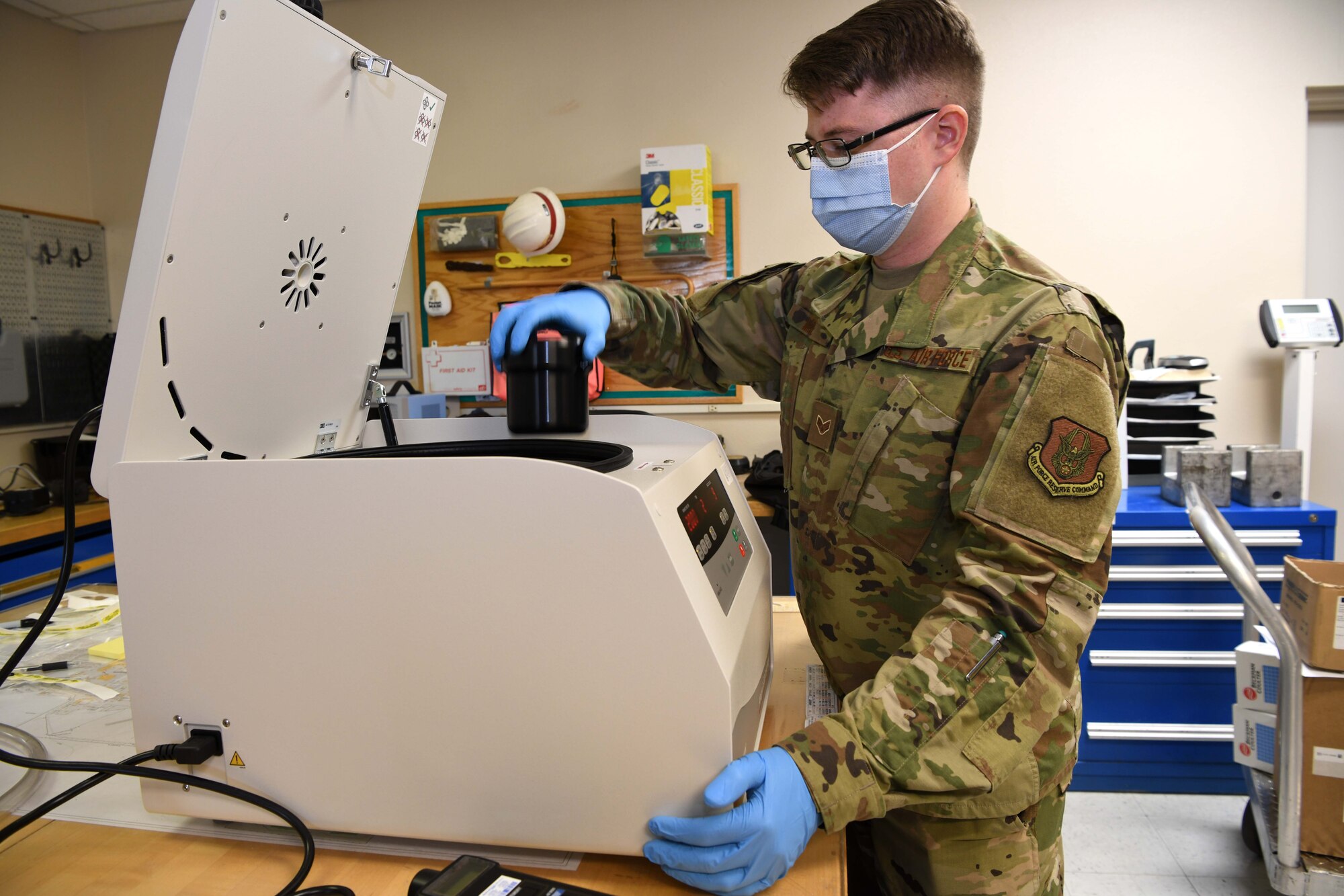 Luke Air Force Base, Ariz. – Senior Airman David Moore, 944th Aeromedical Staging Squadron biomedical technician, places a canister into a centrifuge machine while inspecting the device at Luke Air Force Base, Ariz., Nov. 9, 2020. When testing the machine, Moore verifies the rotation speed and looks for any cracks that would render the device inoperable.