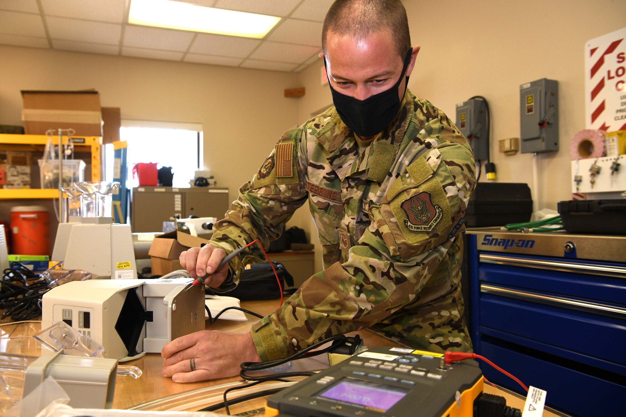 Luke Air Force Base, Ariz. – Staff Sgt. Cliff Stebbins, 944th Aeromedical Staging Squadron biomedical technician, measures the electrical current and resistance on a pill counter using a digital multimeter at Luke Air Force Base, Ariz., Nov. 9, 2020. The BMET Airmen are responsible for keeping medical equipment serviceable and configured to safety standards to ensure proper operation during daily use and emergency requirements.
