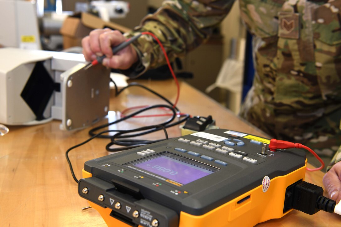 Luke Air Force Base, Ariz. – Staff Sgt. Cliff Stebbins, 944th Aeromedical Staging Squadron biomedical technician, measures the electrical current and resistance on a pill counter using a digital multimeter at Luke Air Force Base, Ariz., Nov. 9, 2020. The BMET Airmen are responsible for keeping medical equipment serviceable and configured to safety standards to ensure proper operation during daily use and emergency requirements.