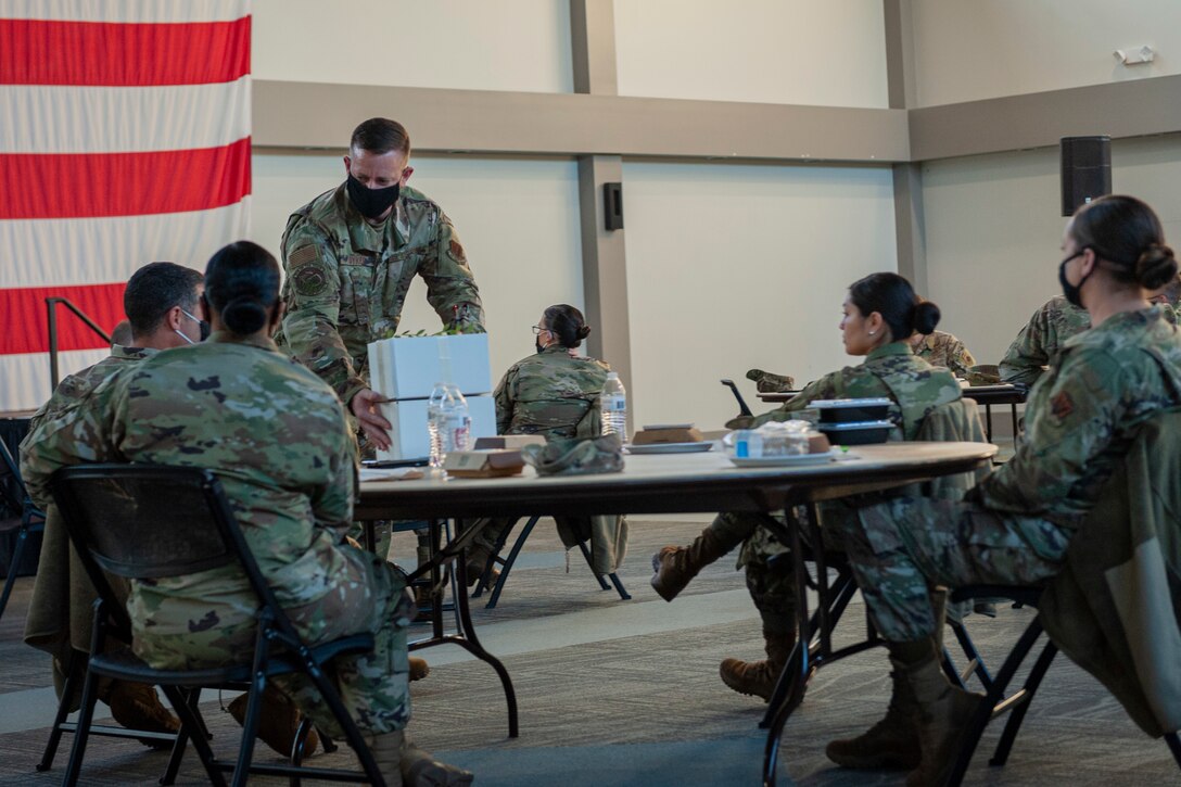 A photo of a person handing out gift boxes.