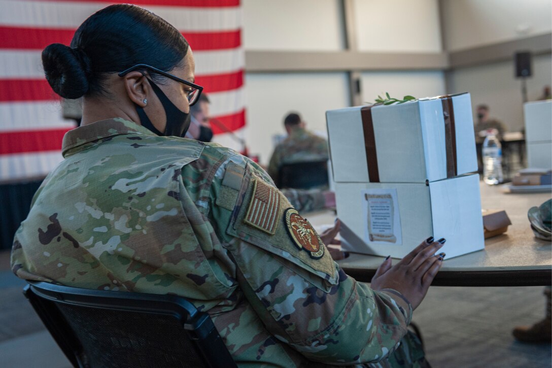 A photo of a person looking at a gift box.